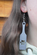 May include: Grey dangle earrings with a paw print design. The earrings are made of a textured material and have a silver hook. (etsy image id: 8005292459)